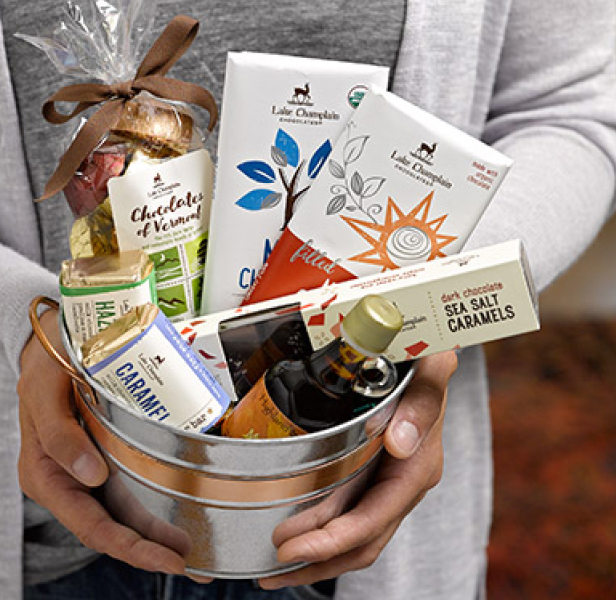 Lake Champlain chocolates gift basket Person holding a gift basket of Lake Champlain Chocolates